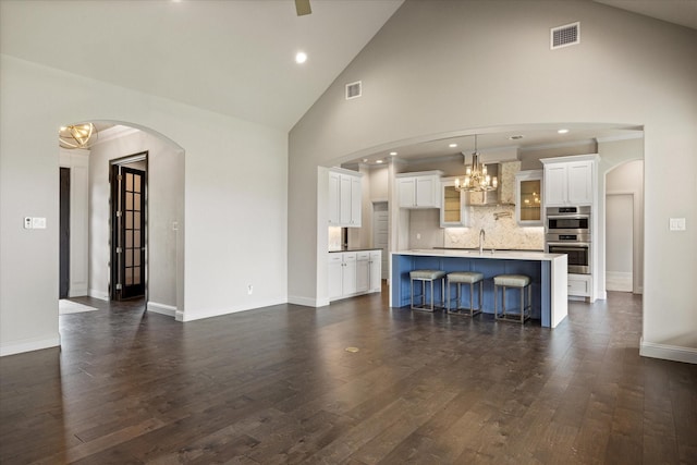 1209 Catalina Bay Blvd, Granbury, TX 76048 - living room with a chandelier, dark wood-style flooring, baseboards, high vaulted ceiling, and recessed lighting
