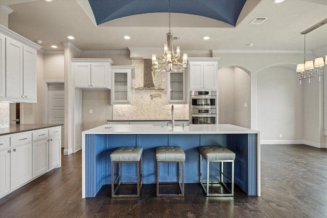 1209 Catalina Bay Blvd, Granbury, TX 76048 - kitchen with wall chimney exhaust hood, stainless steel double oven, a chandelier, white cabinets, and recessed lighting