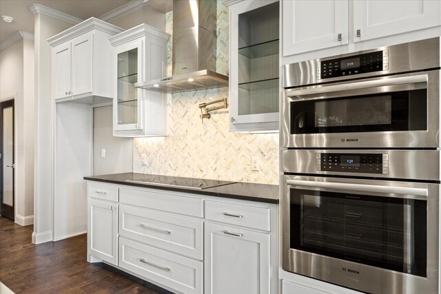 1209 Catalina Bay Blvd, Granbury, TX 76048 - kitchen featuring wall chimney exhaust hood, double oven, black electric cooktop, ornamental molding, and tasteful backsplash