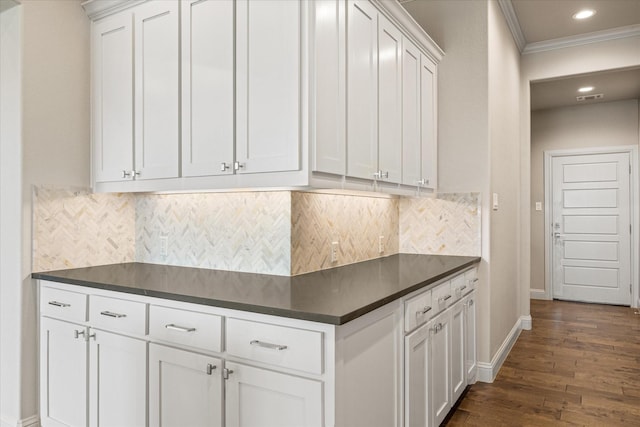 1209 Catalina Bay Blvd, Granbury, TX 76048 - kitchen featuring dark countertops, ornamental molding, dark wood-style flooring, white cabinetry, and baseboards