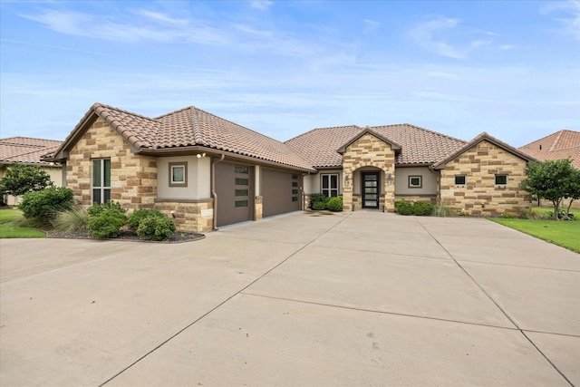 1209 Catalina Bay Blvd, Granbury, TX 76048 - view of front of home with stone siding, driveway, a garage, stucco siding, and a tiled roof