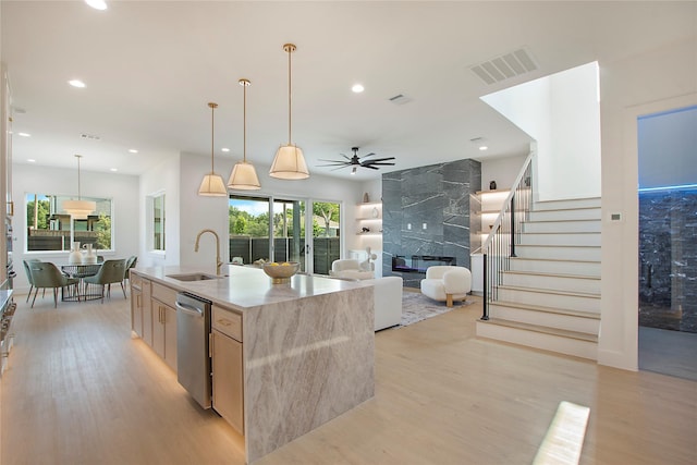 1903 Mcbroom St, Dallas, TX 75212 - kitchen featuring a sink, light brown cabinets, stainless steel dishwasher, a high end fireplace, and light wood-type flooring