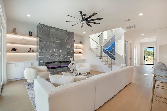 1903 Mcbroom St, Dallas, TX 75212 - living room featuring a ceiling fan, wood finished floors, stairs, a high end fireplace, and recessed lighting
