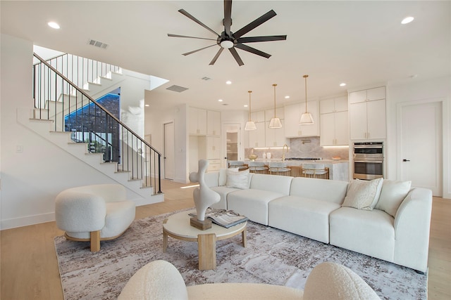 1903 Mcbroom St, Dallas, TX 75212 - living area featuring ceiling fan, light wood-type flooring, stairs, baseboards, and recessed lighting