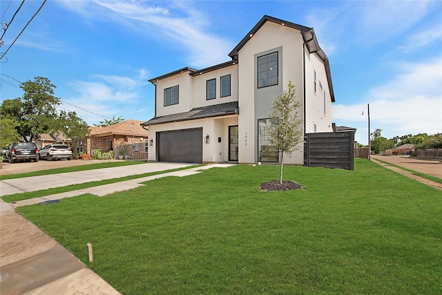 1903 Mcbroom St, Dallas, TX 75212 - view of front of home featuring concrete driveway, stucco siding, and an attached garage