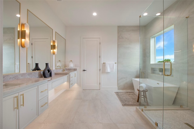 1903 Mcbroom St, Dallas, TX 75212 - bathroom featuring double vanity, a soaking tub, recessed lighting, a shower stall, and baseboards