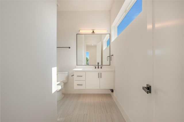 1903 Mcbroom St, Dallas, TX 75212 - bathroom with toilet, vanity, baseboards, and healthy amount of natural light
