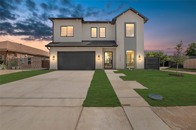 1903 Mcbroom St, Dallas, TX 75212 - view of front of home featuring stucco siding, concrete driveway, and a garage