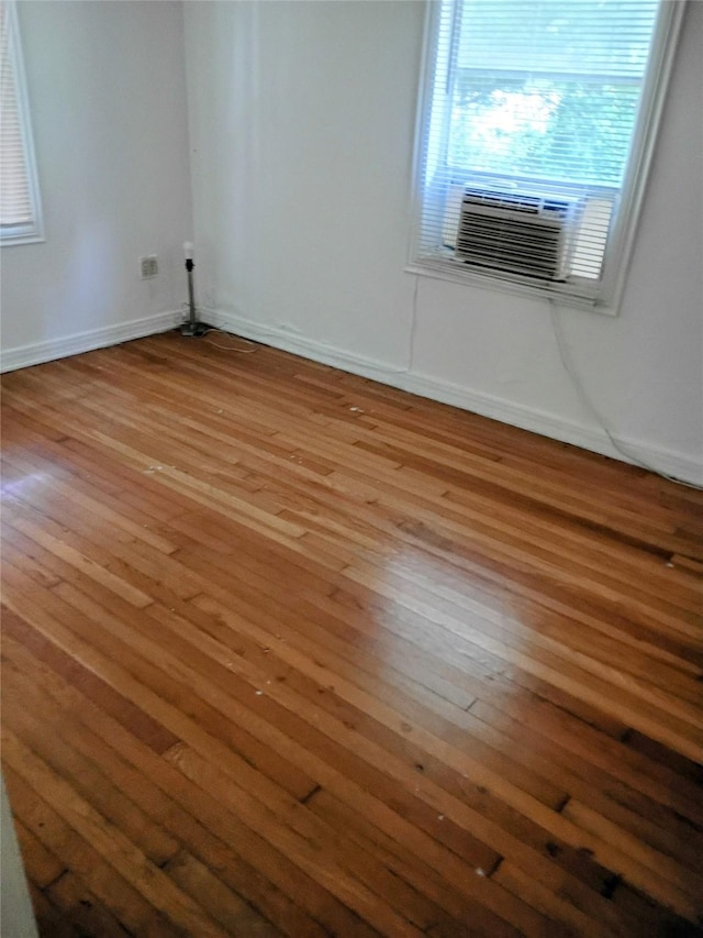 4330 Wabash Ave, Fort Worth, TX 76133 - empty room featuring wood-type flooring, baseboards, and cooling unit