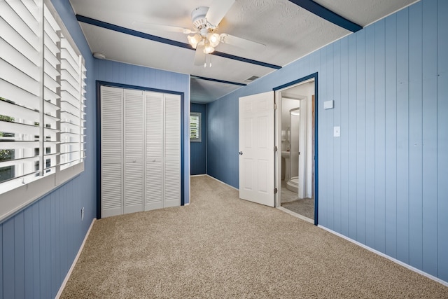 400 Titus St, Mckinney, TX 75069 - unfurnished bedroom featuring a closet, carpet floors, a ceiling fan, wooden walls, and baseboards
