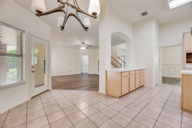1213 Sonoma Dr, Allen, TX 75013 - kitchen featuring light tile patterned floors, light brown cabinets, light countertops, arched walkways, and ceiling fan
