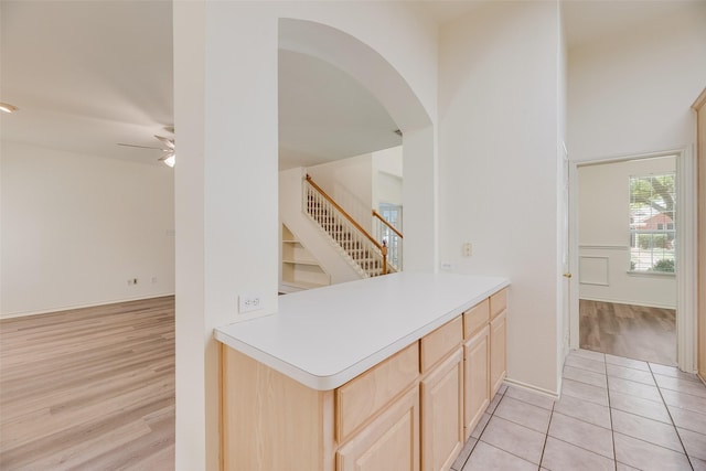 1213 Sonoma Dr, Allen, TX 75013 - kitchen featuring light brown cabinetry, a ceiling fan, arched walkways, and light countertops