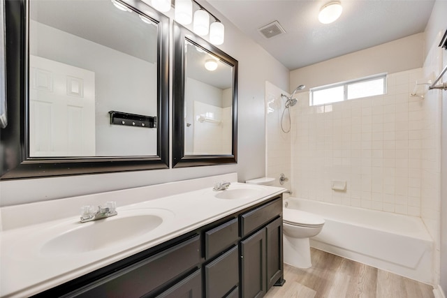 1213 Sonoma Dr, Allen, TX 75013 - bathroom featuring toilet, shower / bath combination, double vanity, and wood finished floors