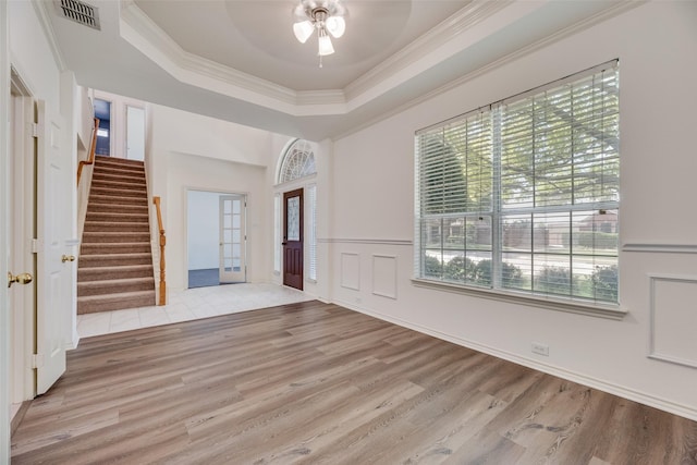 1213 Sonoma Dr, Allen, TX 75013 - entryway featuring stairs, a ceiling fan, wood finished floors, a tray ceiling, and ornamental molding