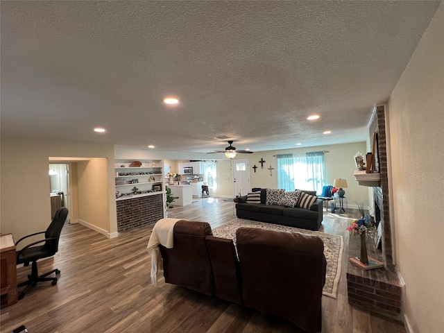1203 Mountainside Dr, Granbury, TX 76048 - living room featuring dark wood-style flooring, a textured ceiling, ceiling fan, baseboards, and recessed lighting