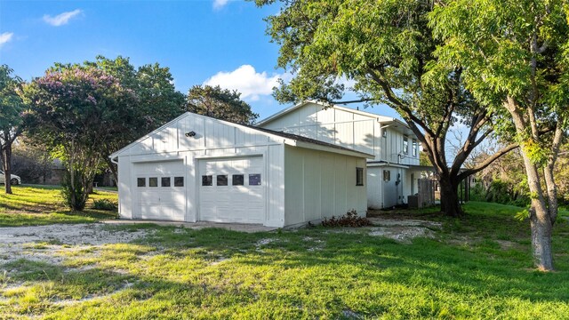1203 Mountainside Dr, Granbury, TX 76048 - view of property exterior with a yard, a garage, and central AC unit