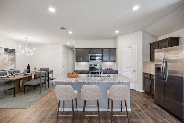 913 Alton Dr, Aubrey, TX 76227 - kitchen with appliances with stainless steel finishes, dark wood-type flooring, tasteful backsplash, and recessed lighting
