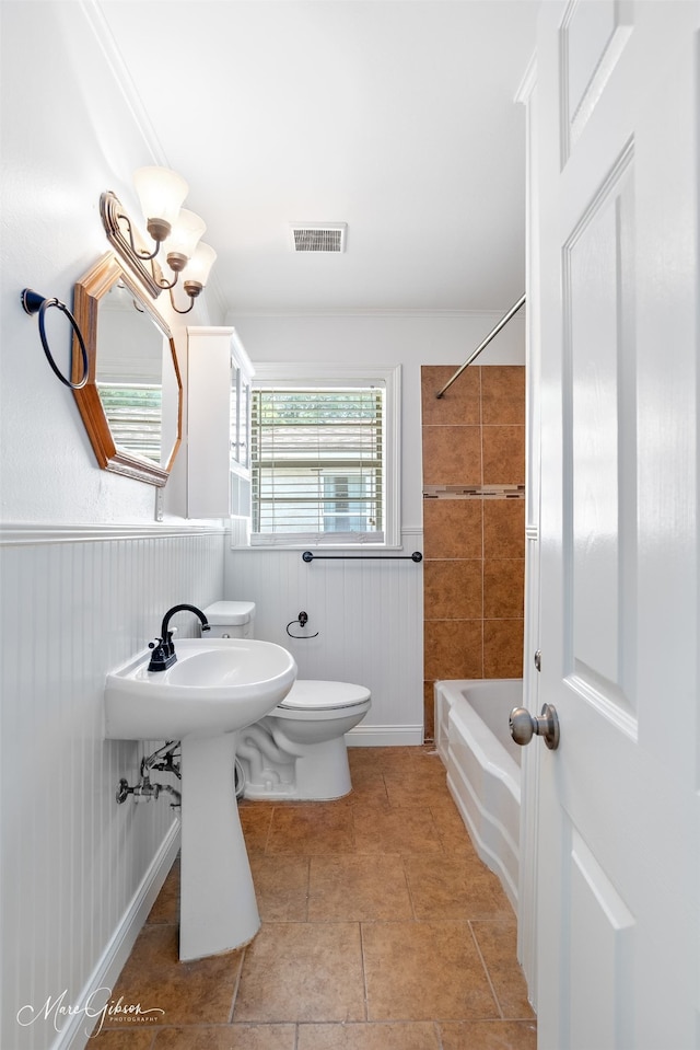 5710 Grover Pl, Shreveport, LA 71105 - bathroom featuring toilet, a wainscoted wall, bathtub / shower combination, and tile patterned floors