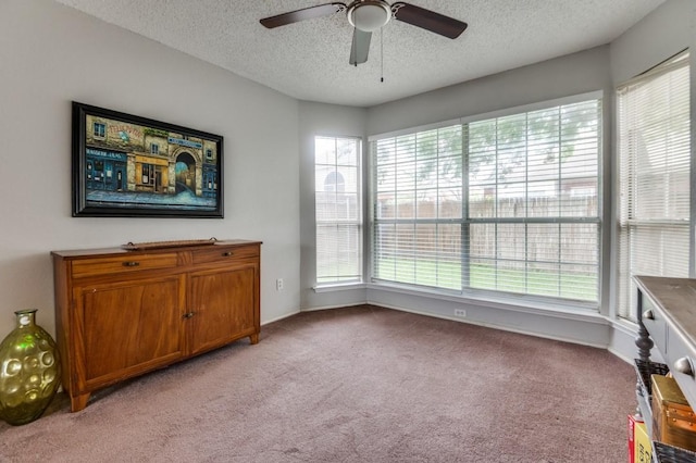 238 Browning Ln, Grand Prairie, TX 75052 - living area with healthy amount of natural light, light carpet, a textured ceiling, and ceiling fan