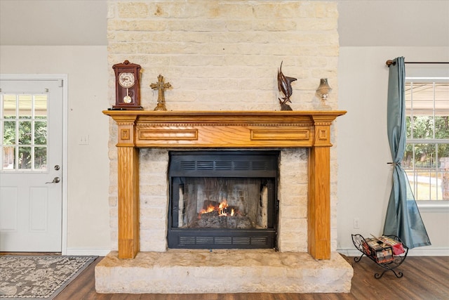 2809 Rock Church Hwy, Tolar, TX 76476 - detailed view of wood finished floors, baseboards, and a large fireplace