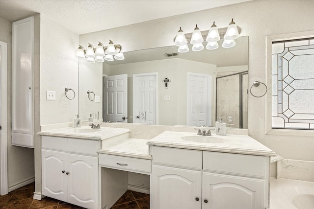 2809 Rock Church Hwy, Tolar, TX 76476 - bathroom featuring double vanity, a textured wall, a bathtub, a shower with door, and tile patterned flooring