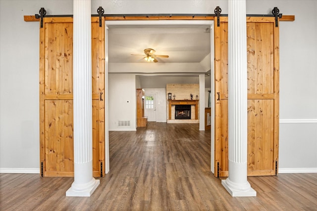 2809 Rock Church Hwy, Tolar, TX 76476 - hallway with a barn door, wood finished floors, and baseboards