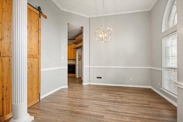 2809 Rock Church Hwy, Tolar, TX 76476 - unfurnished dining area featuring wood finished floors, a chandelier, crown molding, a barn door, and baseboards