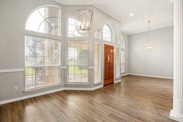 2809 Rock Church Hwy, Tolar, TX 76476 - foyer entrance featuring a chandelier, crown molding, wood finished floors, and baseboards