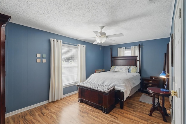 177 Graben Ln, Rhome, TX 76078 - bedroom featuring wood finished floors, baseboards, a textured ceiling, and ceiling fan