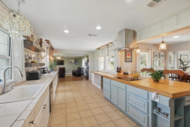 177 Graben Ln, Rhome, TX 76078 - kitchen featuring a sink, black electric cooktop, light tile patterned floors, open floor plan, and butcher block counters