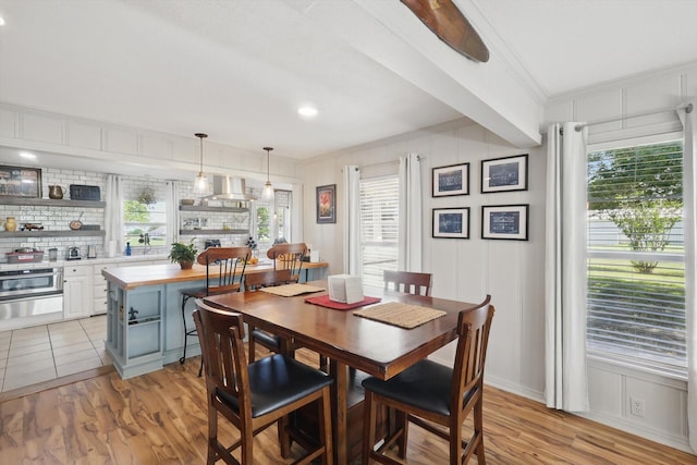 177 Graben Ln, Rhome, TX 76078 - dining space with ornamental molding, light wood-style floors, healthy amount of natural light, and a decorative wall