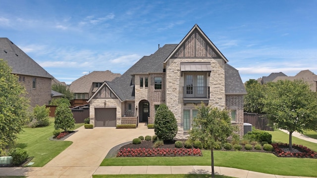 4350 Bristleleaf Ln, Prosper, TX 75078 - english style home with stone siding, a balcony, driveway, an attached garage, and brick siding