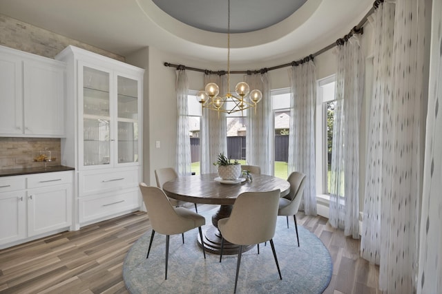 4350 Bristleleaf Ln, Prosper, TX 75078 - dining space with light wood finished floors, a chandelier, and a raised ceiling