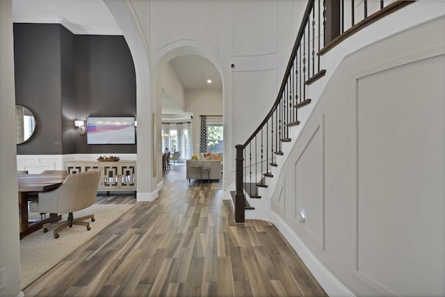 4350 Bristleleaf Ln, Prosper, TX 75078 - foyer featuring a towering ceiling, wood finished floors, stairway, baseboards, and arched walkways