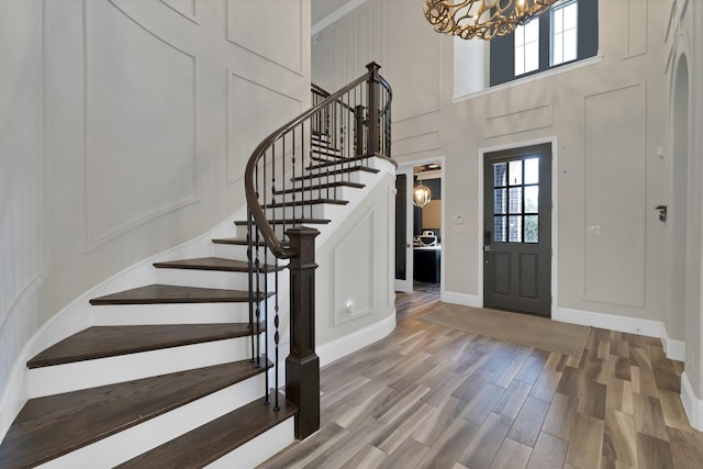 4350 Bristleleaf Ln, Prosper, TX 75078 - foyer entrance featuring a chandelier, stairs, light wood finished floors, a high ceiling, and baseboards