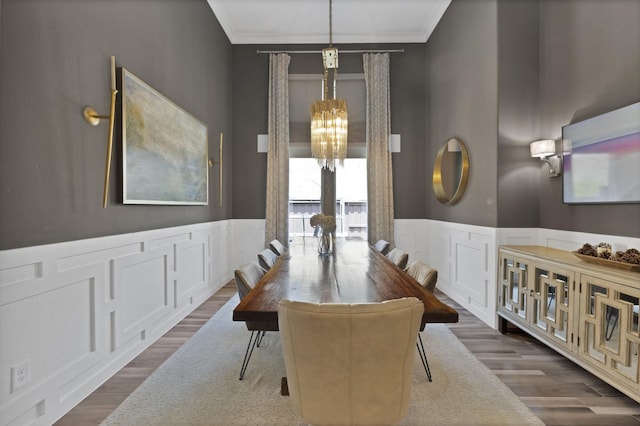 4350 Bristleleaf Ln, Prosper, TX 75078 - dining area featuring a chandelier, crown molding, wainscoting, a decorative wall, and dark wood-type flooring