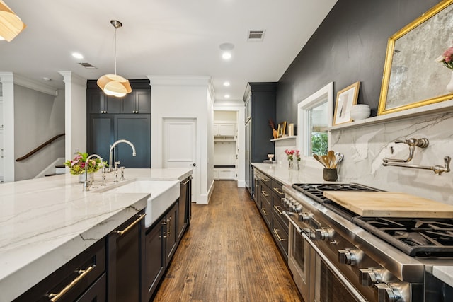 1260 Stanhope Ct, Southlake, TX 76092 - kitchen with dark wood-style flooring, light stone countertops, ornamental molding, tasteful backsplash, and hanging light fixtures
