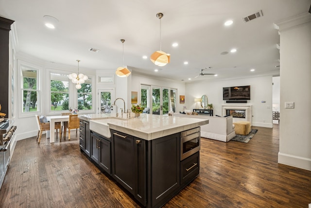 1260 Stanhope Ct, Southlake, TX 76092 - kitchen featuring stainless steel microwave, ornamental molding, healthy amount of natural light, recessed lighting, and dark wood-style flooring