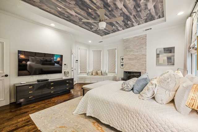1260 Stanhope Ct, Southlake, TX 76092 - bedroom featuring a tray ceiling, wood finished floors, crown molding, a fireplace, and recessed lighting