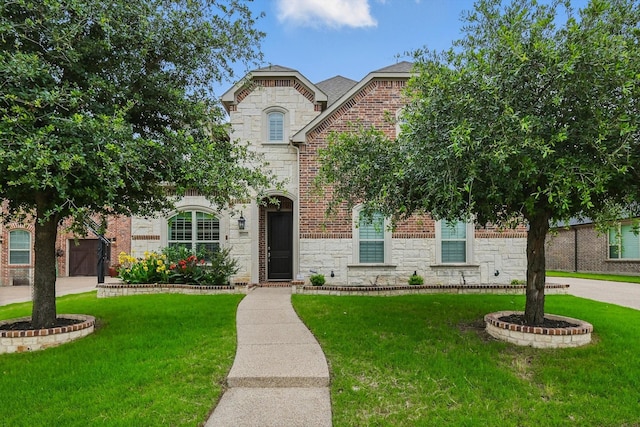2866 Milsons Point Dr, Trophy Club, TX 76262 - french country home featuring stone siding, a front yard, and brick siding
