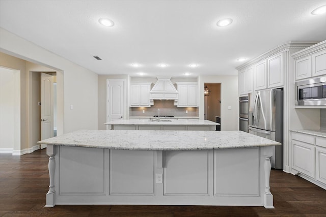 2866 Milsons Point Dr, Trophy Club, TX 76262 - kitchen featuring stainless steel appliances, a spacious island, premium range hood, recessed lighting, and dark wood finished floors
