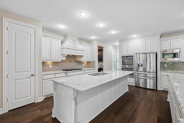 2866 Milsons Point Dr, Trophy Club, TX 76262 - kitchen with stainless steel appliances, premium range hood, dark wood-type flooring, tasteful backsplash, and white cabinetry