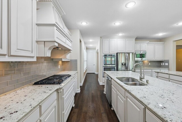2866 Milsons Point Dr, Trophy Club, TX 76262 - kitchen featuring stainless steel appliances, white cabinetry, dark wood-style flooring, decorative backsplash, and recessed lighting