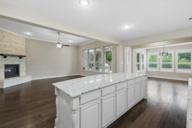 2866 Milsons Point Dr, Trophy Club, TX 76262 - kitchen featuring ceiling fan, dark wood-style flooring, crown molding, open floor plan, and white cabinets