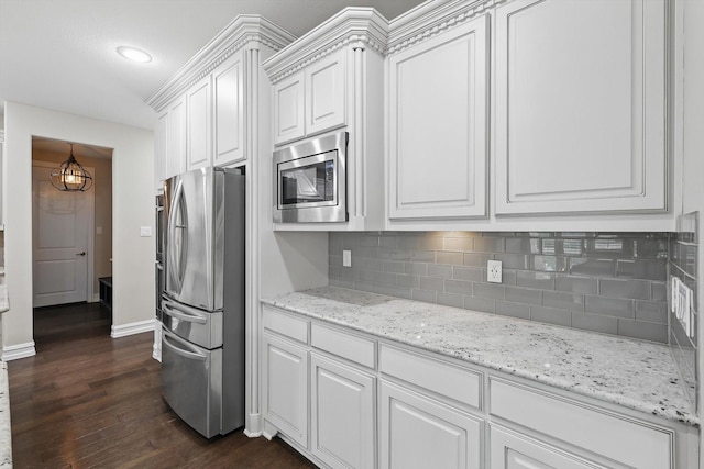 2866 Milsons Point Dr, Trophy Club, TX 76262 - kitchen featuring appliances with stainless steel finishes, dark wood finished floors, decorative backsplash, white cabinetry, and recessed lighting