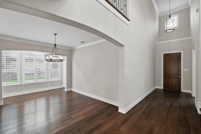 2866 Milsons Point Dr, Trophy Club, TX 76262 - foyer with a chandelier, dark wood-style flooring, crown molding, and arched walkways