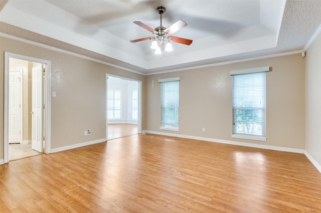 4465 Northern Dancer Dr, Burleson, TX 76028 - spare room with a raised ceiling, healthy amount of natural light, light wood-style floors, crown molding, and a textured ceiling