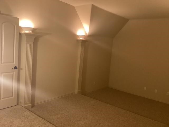 6916 Cannon Falls Dr, Plano, TX 75024 - additional living space with ornate columns, carpet floors, and vaulted ceiling