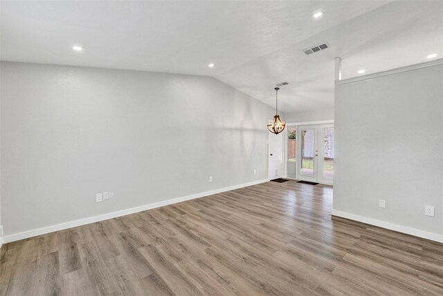 2308 Foxcroft Ln, Arlington, TX 76014 - spare room featuring vaulted ceiling, recessed lighting, a chandelier, wood finished floors, and baseboards