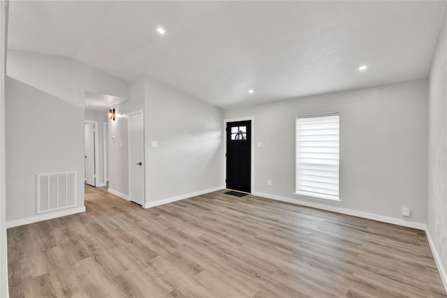 2308 Foxcroft Ln, Arlington, TX 76014 - unfurnished living room featuring light wood-style floors, lofted ceiling, baseboards, and recessed lighting